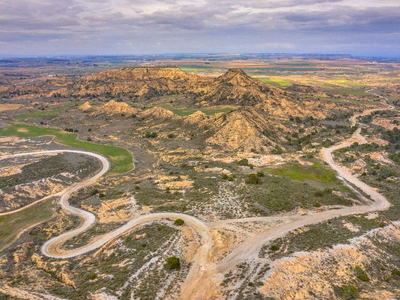 Aerial,View,Of,Dirt,Road,Through,Arid,Landscape,Of,Castejon